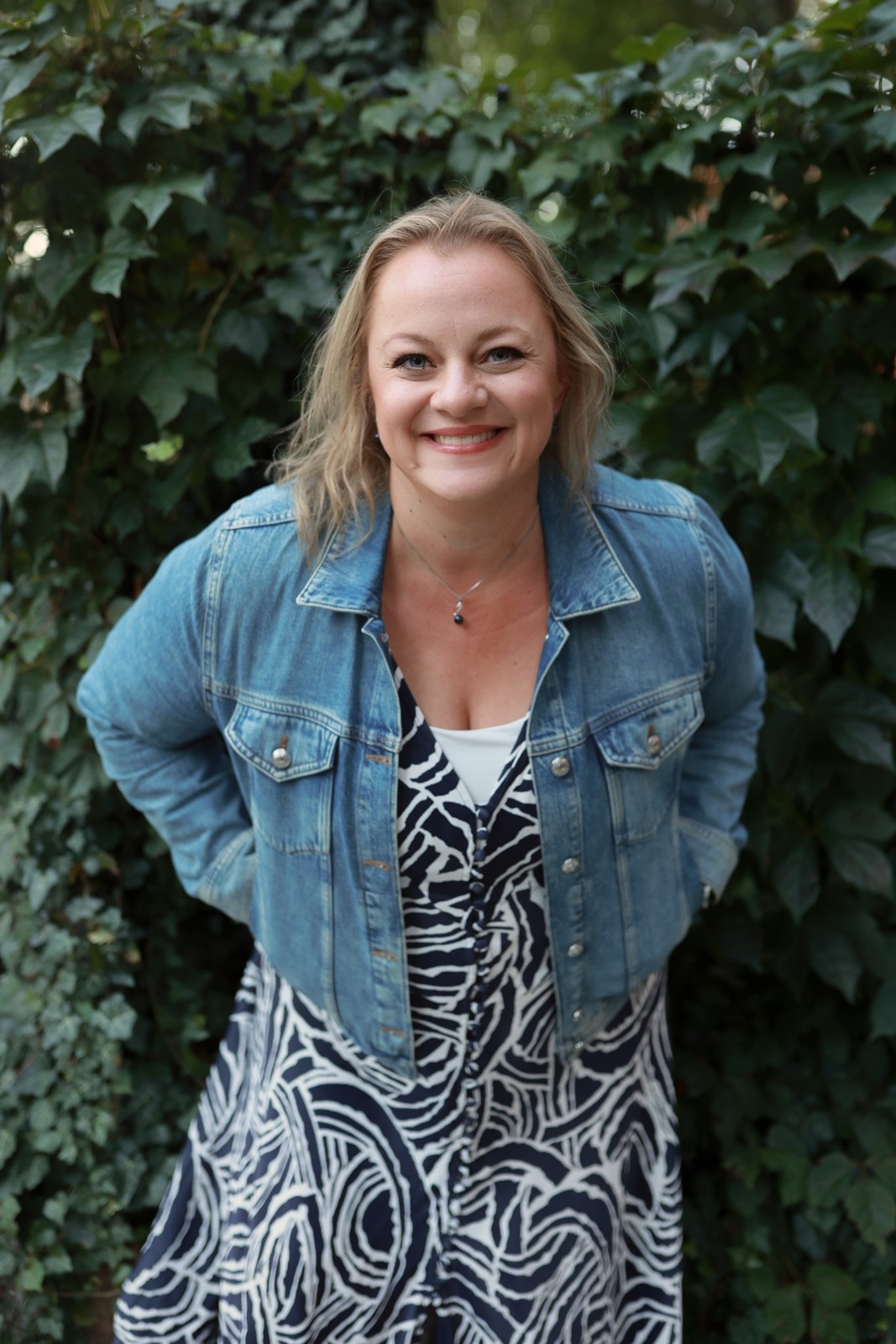 Kris Porter, travel advisor, smiling in a denim jacket